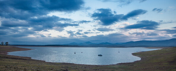 Leisure boats anchored on the shore of the Gabriel y Galan reservoir