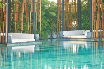 sofa beside swimming pool in resort hotel