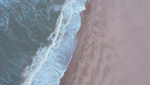 Drone view of sea waves splashing on sandy beach near La Coubre in Charente Maritime, France