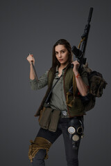 Middle Eastern woman, dressed in post-apocalyptic survivalist gear, poses with a dagger and an...