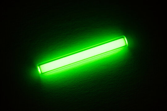 Tritium. Radioactive glow. Gaseous tritium light source in a glass vial. Radiation green glow hazards to employees, visitors, inspectors. Irradiated zone. Neon luminous fluorescence, phosphorescence