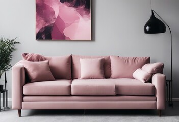 Grey sofa with pink pillows and blanket against white wall with abstract art poster Interior design