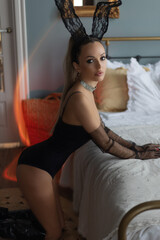 Fototapeta premium sexy woman in a black body on chair.