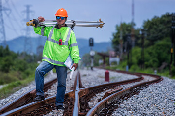 Worker  on the railway.  worker on a construction site. construction worker with helmet. Survey man  working on railway. construction worker on railway site. - obrazy, fototapety, plakaty