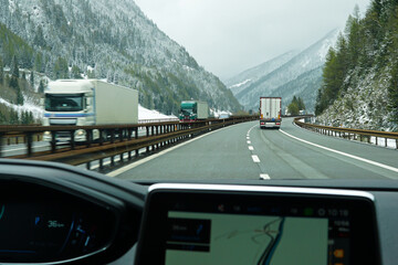 Snowy mountain cliff and cloudy sky with traffic view on Brennero Autostrada motorway to Innsbruck,...
