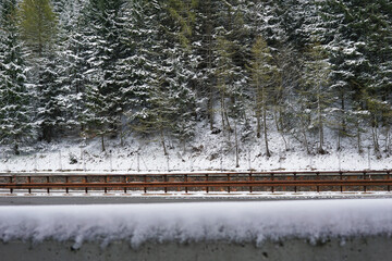Snowy mountain cliff and cloudy sky with traffic view on Brennero Autostrada motorway to Innsbruck,...