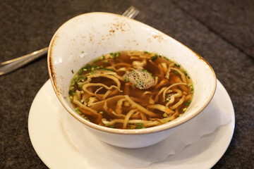 Close up bowl of clear beef bouillon soup Consommé