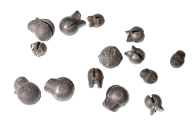 A collection of pinch style split shot lead fishing weights on a clean background.