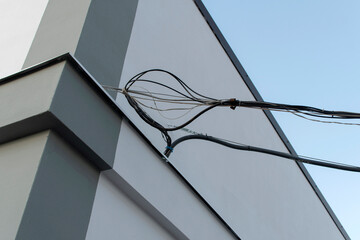 Electric wires on a wall of a building