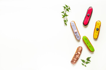 Pattern of various glased eclairs cakes. Sweet food background