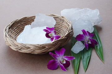 Crystal clear alum stones or Potassium alum decorated with flowers and leaves. Useful for beauty and spa treatment. Use to treat body odor under the armpits as deodorant and make water clear.        