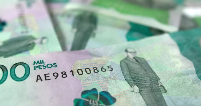 Colombian money pesos bills falling on a table COP 4K 