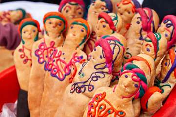 Group of bread dolls decorated with colorful colors to visit the deceased on Saints' Day in Otavalo Ecuador