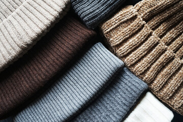 Assorted gray and brown knitted hats next to each other