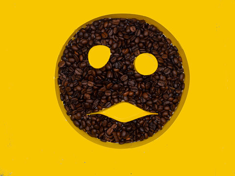 Coffee beans smile fave on yellow background