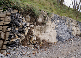 Rock and cut stone along a road under construction in a natural area - 675930724