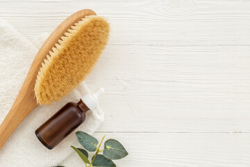 Massage and bath brush with cosmetic oil. Spa set concept