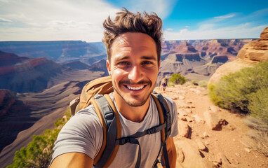 A young backpacker takes a selfie with a fantastic view behind him