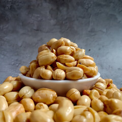 Kacang Goreng or fried peanuts which are given garlic seasoning with salty and savory flavor. Indonesian traditional snack.