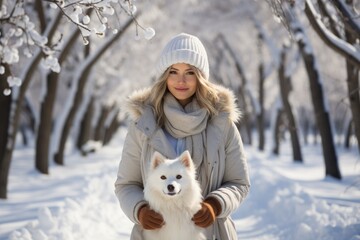 woman with white  dog in winter park