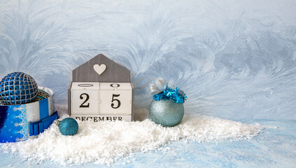 Christmas mood, New Year background. Sparkling Christmas balls on the snow and a calendar with the...