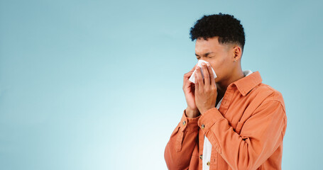 Man, blowing and nose for sinus in studio for healthcare mock up on blue background in Cape Town....