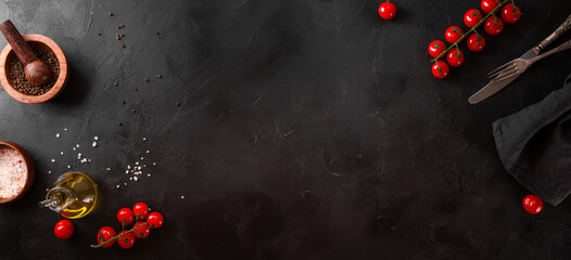 Food background, spices, tomatoes and oil on a black background, web banner with free space for text