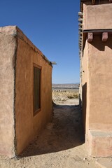 Alley between buildings looking over the plain, Acoma, New Mexico