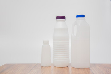 Plastic milk bottle recycling on white background