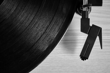 Classic vinyl record player closeup. Black and white photo has top view.