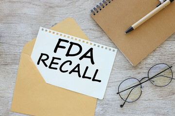 FDA recall text on paper on an envelope. glasses on the table