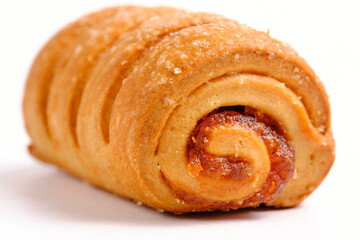 Roll roll with jam sprinkled with sugar, confectionery and pastries. On white background.