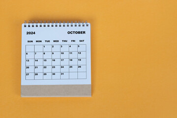 October 2024 desk calendar on yellow background. Directly above. Flat lay.