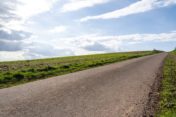 Fototapeta premium Path on the hill in landscape with blue sunny sky