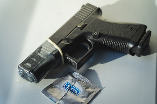 Baltic States, August 25, 2023.  Glock 19 pistol with a Durex condom attached to the barrel.