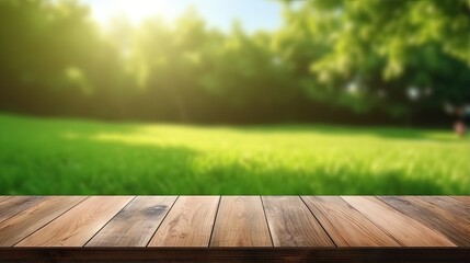 Wood table top on blurred lawn green background for montage or display your products