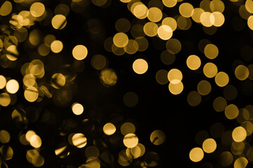 Gold abstract christmas bokeh on black background