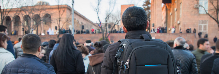 man in backpack in street