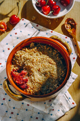 cobbler pie with cherries in ceramic form, sunlight, rustic style, close-up, food, bowl, meal, dinner, red, fruit cake, wooden spoon, sweets, delicious, dessert