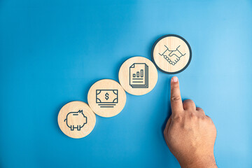 Fototapeta premium Financial innovation technology development and business management concepts, Businessman holding bank, and financial icon services that enhance success and profit in global business