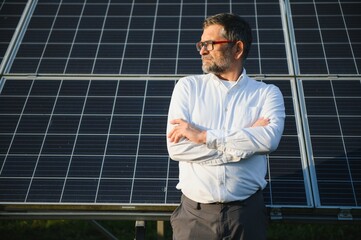 Architect standing by solar panels.