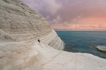 Tourist admiring the white limestone cliffs of the Scala dei Turchi, Agrigento, Sicily, Italy, 