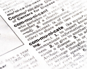 Naklejka premium Closeup of the definition of the word communicate