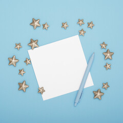 Blank greeting card for your text with pen and decorative stars on cyan background