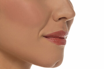 Close-up, side view of a woman's mouth on white background