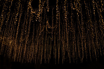 Gold abstract christmas bokeh on black background