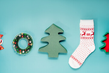 Minimalist Christmas mood concept. Turquoise Background with Christmas attributes as Christmas tree...