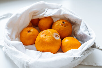 tangerines in fabric bag