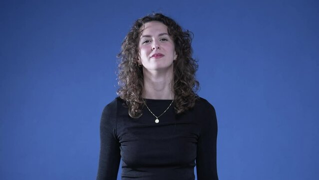 Proud woman pointing to self giving thumbs up recognizing her own success
