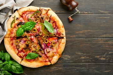  Homemade pizza. Traditional neapolitan pizza with olives, peppers, onions and mushrooms on wooden...